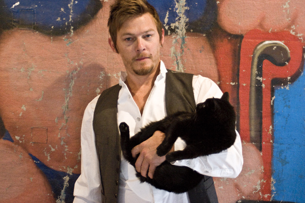 Norman Reedus holding a black cat