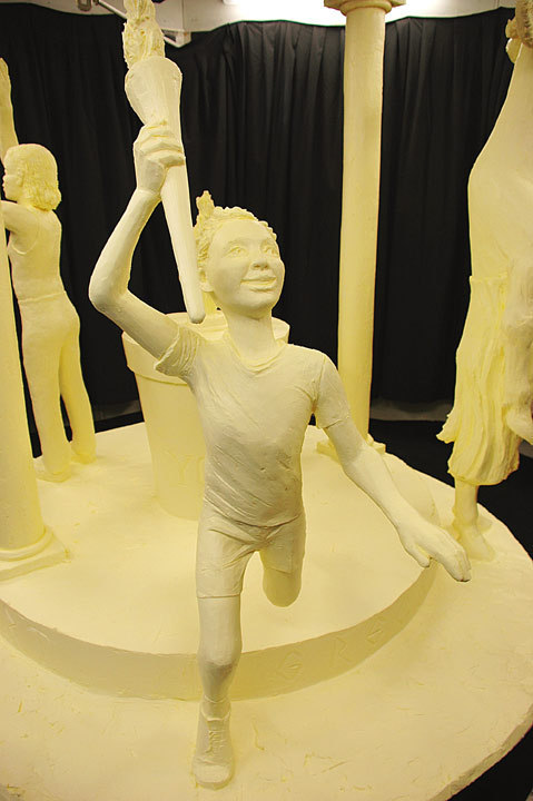 butter food sculpture: boy with torch