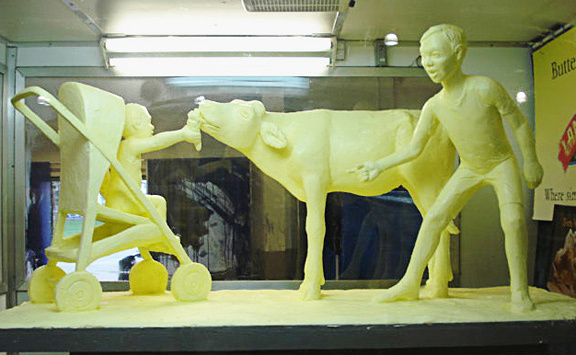 butter food sculpture: cow, boy, baby stroller