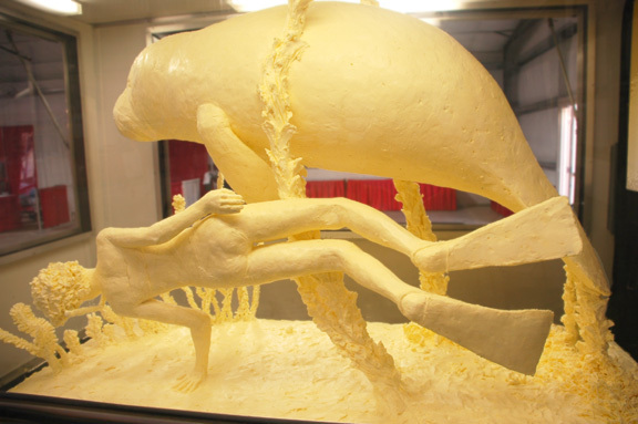 butter food sculpture: manatee and diver